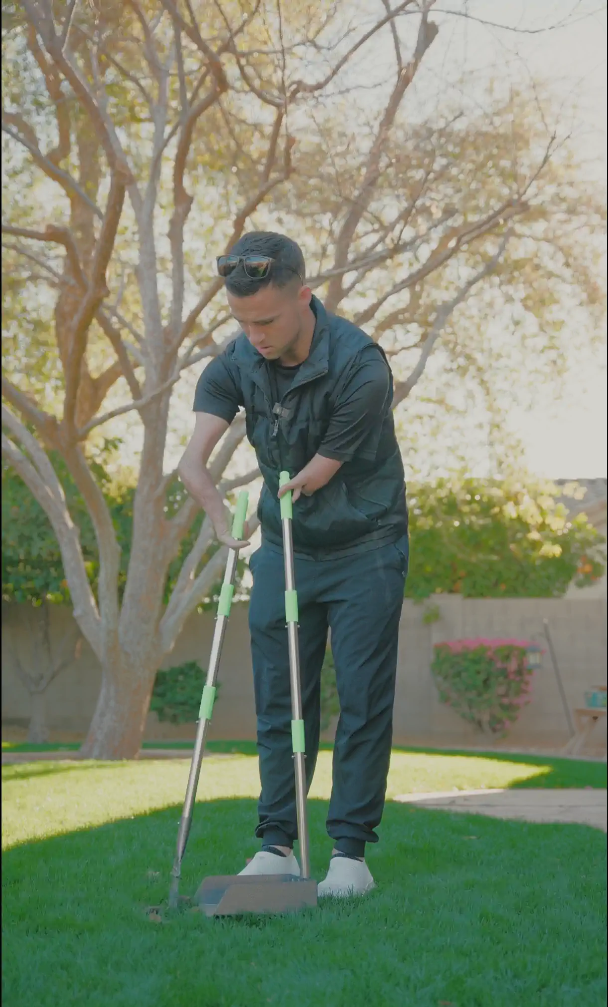 An Arrowhead Pooper Scoopers team member scooping a clean green backyard