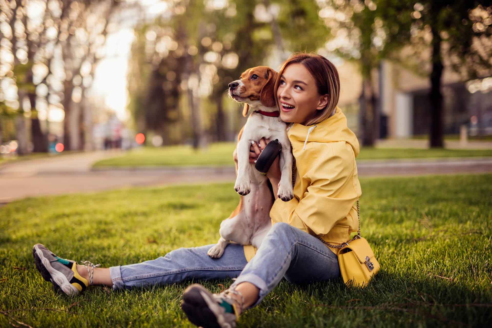 A dog owner relaxing in a clean grassy yard